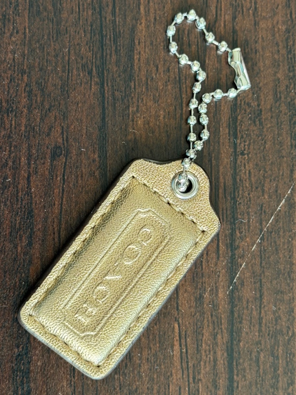 Coach gold bag leather hang tag